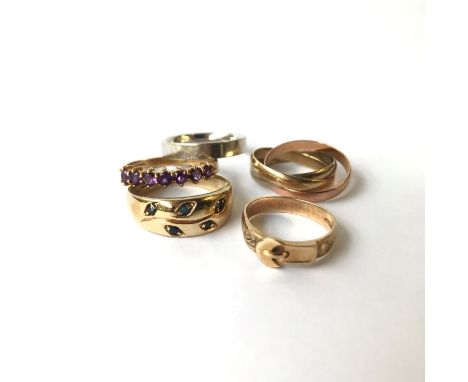 A 9ct gold three colour triple ring and four other gold rings.