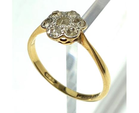 An 18ct. gold ring set a flower head diamond cluster