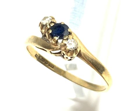 A sapphire and diamond three stone crossover ring