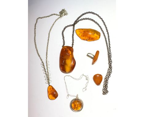 Three amber necklaces, the largest pendant 6.9 x 3.9cm, an amber pendant, an amber ring and an amber brooch.