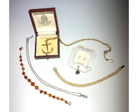 A gilt anchor pendant and chain, two unmounted aquamarine and two bracelets.
