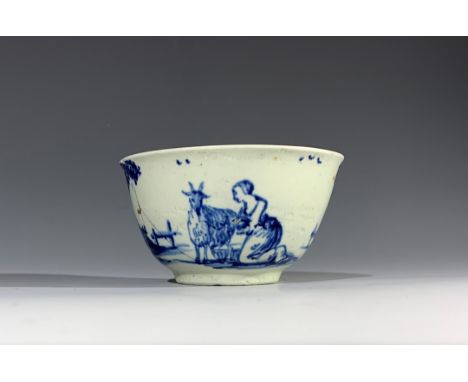 A very rare Vauxhall tea bowl, circa 1756, with English style blue and white decoration depicting a girl milking a goat amids