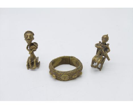 Two African cast brass figures of musicians, height 7.5cm, and a brass bangle.