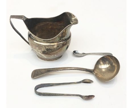 A silver helmet cream jug with reeded rim and base, a silver ladle 6.9oz and a pair of silver plate sugar tongs.