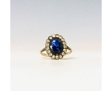 A blue stone and diamond oval cluster ring.Condition report: Size M/N Blue stone not known but presumed to be a striated sapp