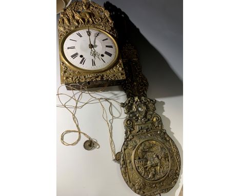 A French comptoise wall clock, 19th century, with white enamel dial, the brass case and pendulum with embossed rustic scenes 
