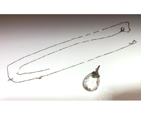 A fine white metal long chain spaced with small pearls and a pendant