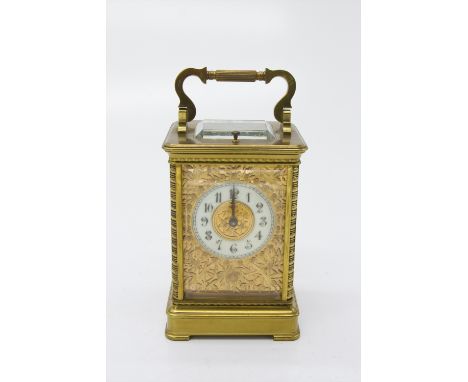 A French late 19th century repeating carriage clock, the matt gilt mask pierced in the aesthetic taste, with cream enamel cha