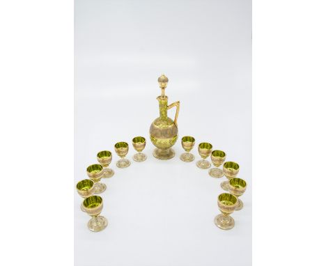 A suite of Venetian gilt glassware comprising a decanter and twelve liqueur glasses. (Dimensions: Decanter height 21.5cm, gla