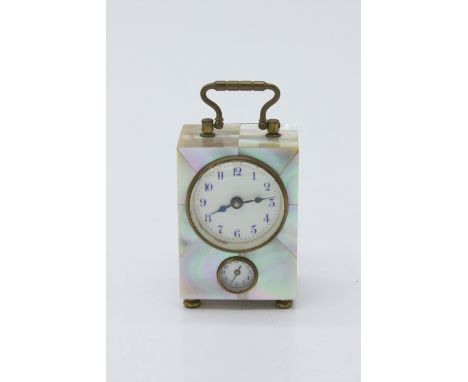 A Miniature German boudoir alarm timepiece, with mother of pearl clad decoration, circular dial and alarm indicator with blue
