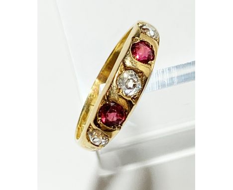 An 18ct gold five stone diamond and ruby ring, 4g.