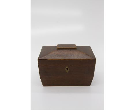 A George III mahogany tea caddy of sarcophagus form, the cover opening to reveal two lidded sections. (Dimensions: Height 14.