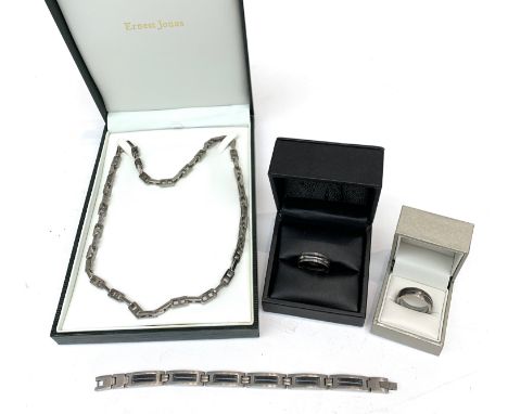 Two titanium rings each set with a diamond and a titanium necklace and bracelet.