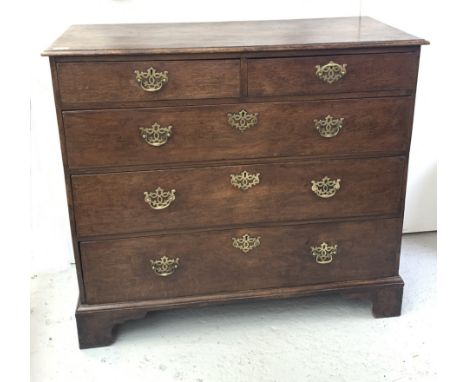 A George III oak chest of drawers, with two short and three long drawers, on bracket feet. (Dimensions: Height 97cm, width 10