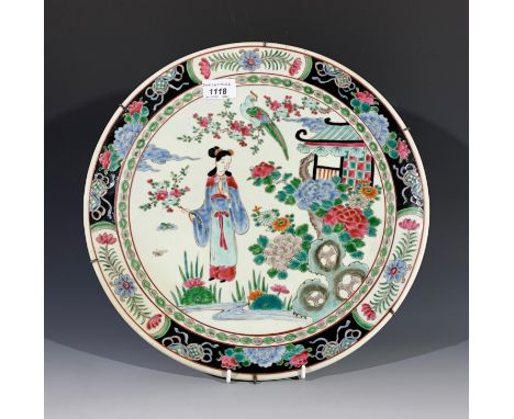 A Chinese famille verte charger, early 20th century, decorated with a garden scene with a female figure, impressed seal mark.