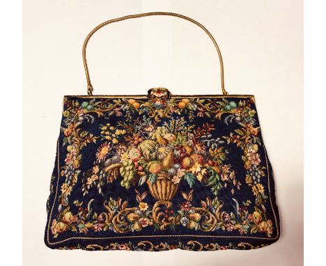 Very fine evening purse of dark blue tapestry style fabric with enamelled gilt metal frame and clasp. The cornucopia style de