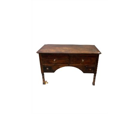 An elm side table, early 20th century, with an arrangement of four drawers, on bobbin turned legs. (Dimensions: Height 77cm, 
