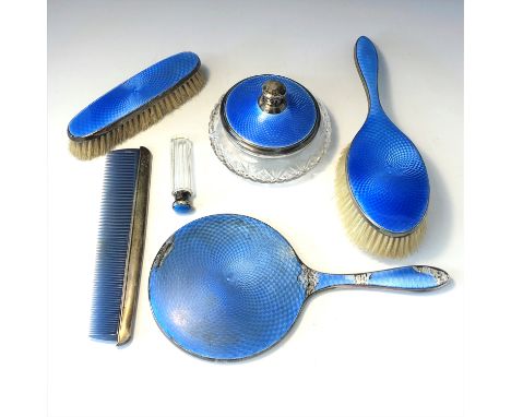 A silver dressing table set with blue guilloché enamel.