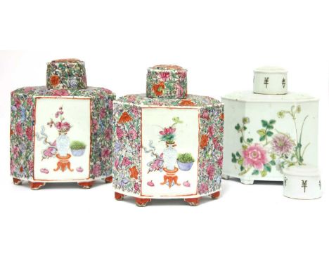 A pair of Chinese famille rose millefleurs tea caddies, Republic period (1912-1949), of hexagonal form on bracket feet, paint