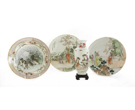 A Chinese famille rose plate, 20th century, of circular form, painted with a lady holding a rabbit in her arms, surrounded by