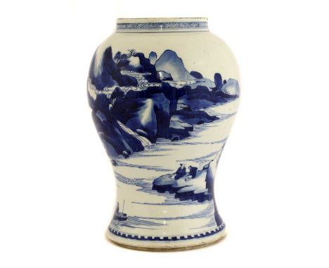 A Chinese blue and white vase,Kangxi (1662-1722), of baluster form, painted with literati seated by a river in a mountainous 