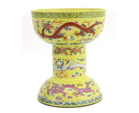 A Chinese famille rose dou, the U-shaped body raised on a cylindrical column above a domed base, painted with dragons chasing