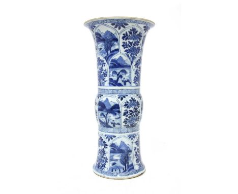 A Chinese blue and white gu vase,Kangxi (1662-1722), of tapering cylindrical form with a flared mouth, painted with landscape