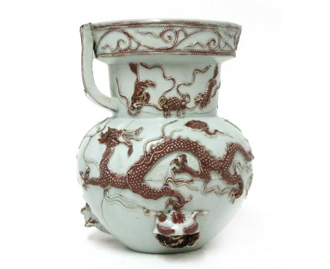 A Chinese iron-red incense burner, of globular form, applied with dragons chasing a flaming pearl in copper-red in relief, th