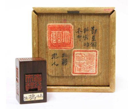 A Chinese wood seal, of rectangular form, containing two seals diminishing in size, each side carved with a seal, 3.8cm long,