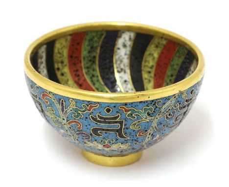 A Chinese cloisonné tea bowl,with deep sides rising from a circular foot, enamelled with Sanskrit characters divided by scrol
