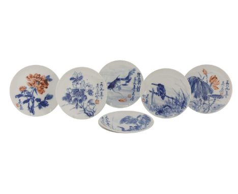 A collection of ten blue and white saucers, each decorated with birds, flowers or carp, signed and dated, 15.2 to 17.5cm diam