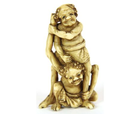 A Japanese ivory okimono, Meiji period (1868-1912), carved with Ashinaga wrestling with Tenaga, 5.5cm high, and a Japanese iv