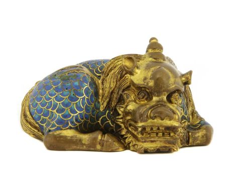 A Chinese cloisonné weight,Qianlong (1736-1795), of a recumbent mythical beast seated on its haunches, its fur cast in detail