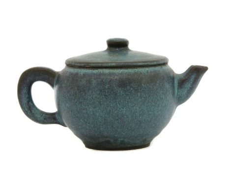 A Chinese Yixing stoneware teapot, of globular form, under a mottled jun-type glaze of streaked blue and purple, the base wit