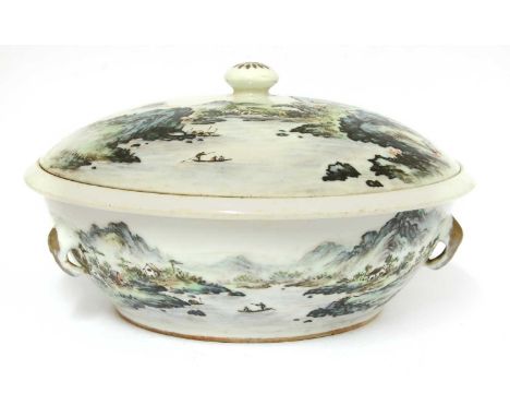 A Chinese porcelain bowl and cover, of circular form with loop ring handles, painted with a continuous landscape, the cover s
