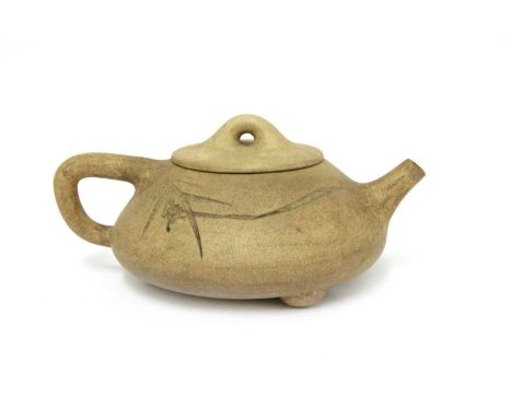 A Chinese zisha teapot and cover, of compressed circular form on three ball feet, incised with bamboo and an inscription, sig