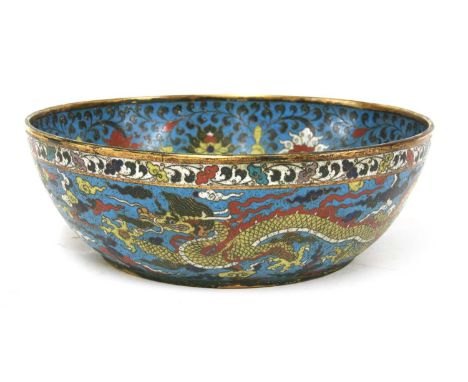 A Chinese cloisonné bowl, of shallow rounded form, the centre enamelled with a bouquet of lotus flowers and seed pods, the si