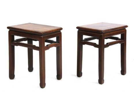 A pair of Chinese hardwood vase stands,late 19th century, each rectangular top above humpback stretchers, on square tapering 