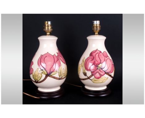 Moorcroft Pair of Bulbous Shaped Lamp Bases with Pink Magnolia Design on Cream Ground, Raised on Circular Wooden Bases. Each 