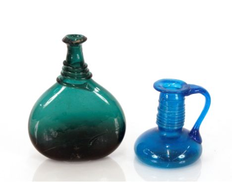 An early Persian green glass bottle,&nbsp;with serpent coiled decoration, 23cm high; and a Persian blue glass pitcher with li