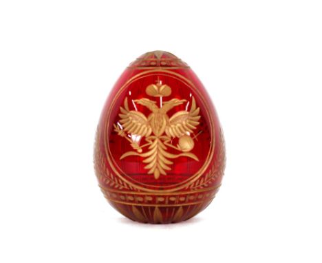 A Fabergé ruby glass and gilt decorated egg
