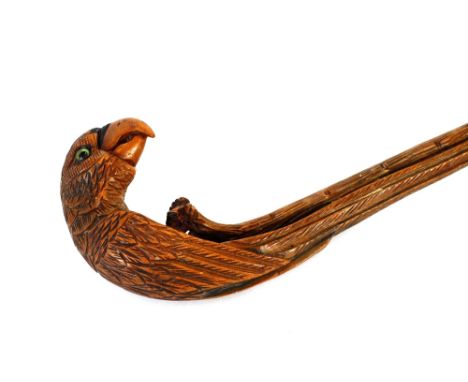 A green stained walking stick,&nbsp;with carved parrot handle&nbsp;