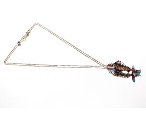 A white metal and enamel decorated articulated fish pendant,&nbsp;hung to a fine link chain