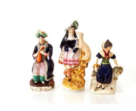 A Victorian Staffordshire figure,&nbsp;of a highland maid with greyhound; another "Mora"; and a seated figure of a lute playe