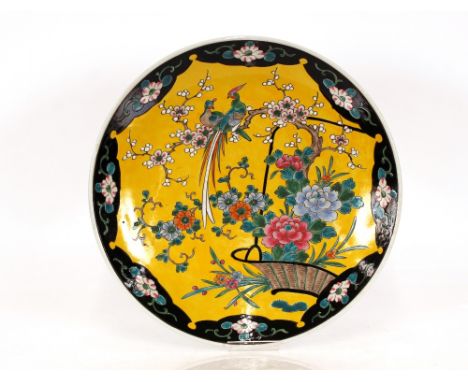 A Japanese Arita ware porcelain charger,&nbsp;of large size , the yellow plateau painted with birds amongst foliage with blac