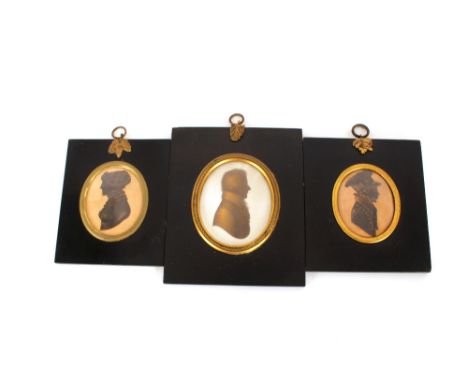 A 19th Century silhouette miniature,&nbsp;of a young man wearing a cap, printed label to verso "Cut With Common Scissors, by 