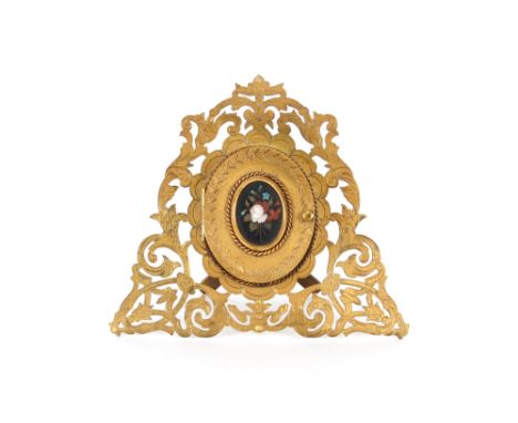 A 19th Century brass easel folding miniature portrait frame,&nbsp;the hinged lid inset with a foliate Pietra Dura panel, 14cm