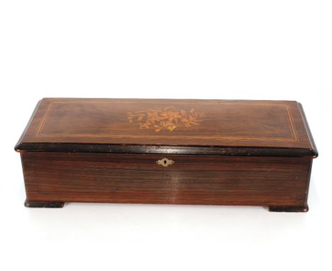 A Swiss music box,&nbsp;playing twelve airs in inlaid case, 63cm long