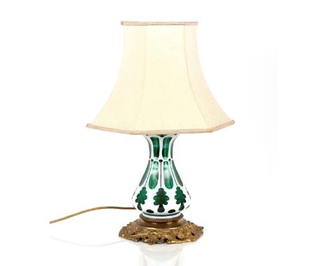 An overlaid green glass baluster table lamp,&nbsp;on gilded base, 33cm high (without shade)