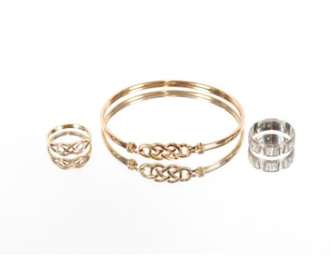 A 9ct gold ring with pierced link decoration; and a similar&nbsp;design bangle, 8gms; and a 9ct white gold band 3.3gms (3)